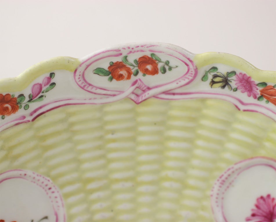 A rare First Period Worcester porcelain yellow ground junket dish painted with bouquets of English flowers