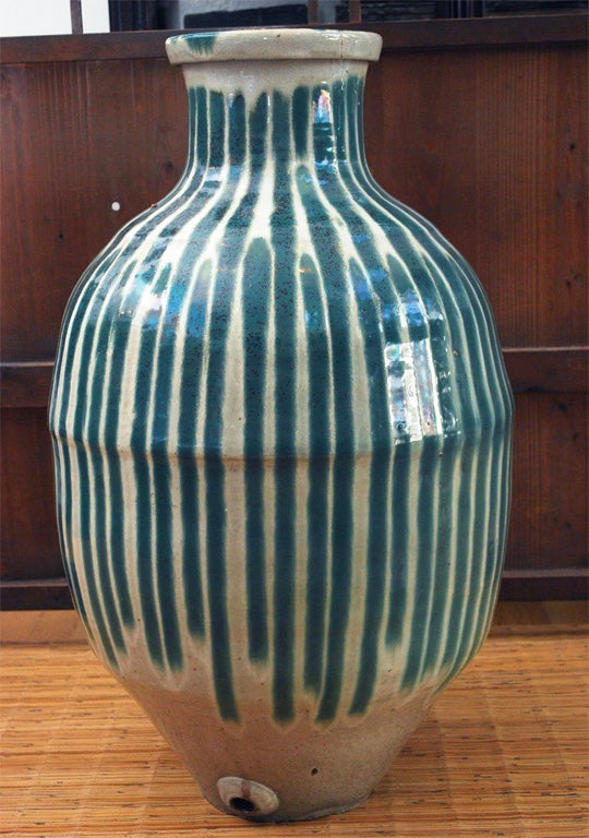 Green and white stripe graze jar is typical of Shigaraki Jars in the 19th century. Used to store sake or soy source for domestic use.