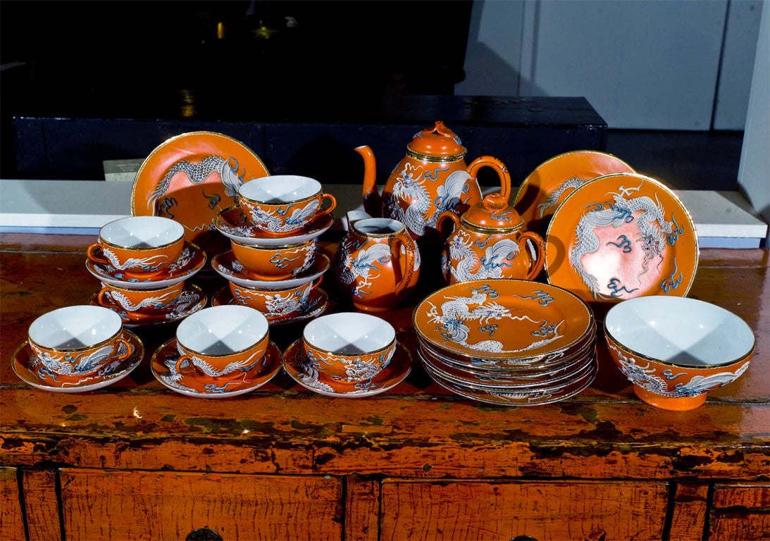 This Chinese set is ready for a tea party.  Bright orange, raised dragons.  Turqoise squiggles are around the dragons.  It isn't perfect but it sure is fun!  8 cups 3.75, 2.2 high,<br />
9 saucers 5.5 diameter, 9 dessert plates 7.25 diameter, 1 tea