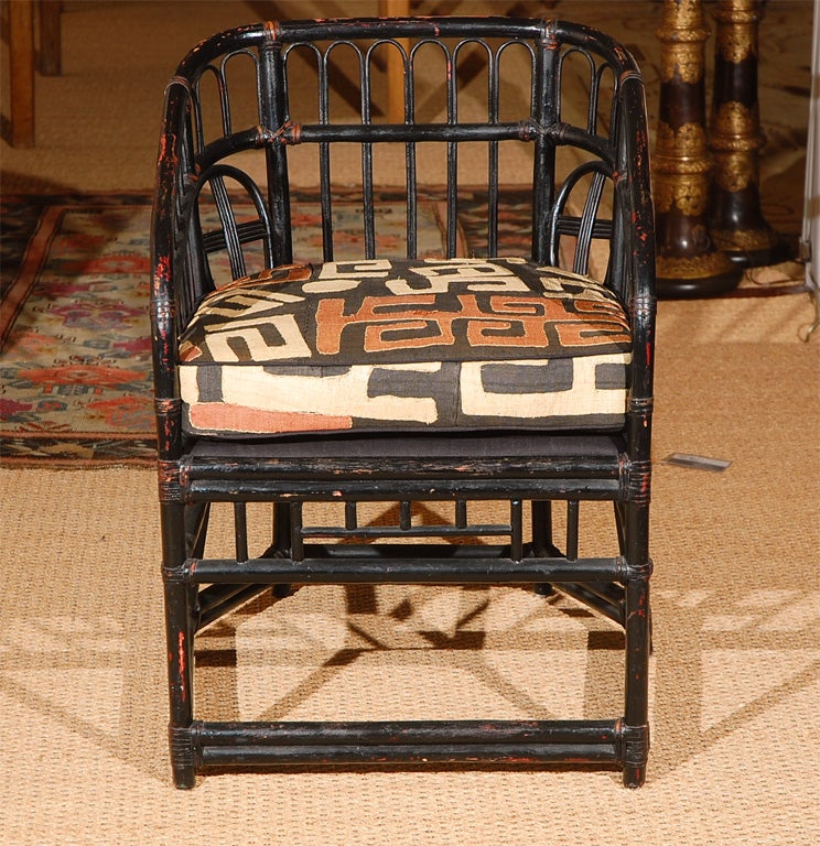 Vintage rattan.   New seat cushions upholstered with raffia kuba cloth.  Distressed paint finish.