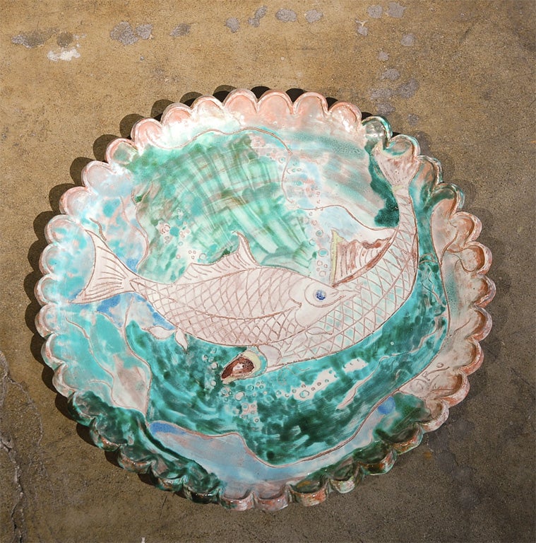 Very large handmade platter with beautiful renderings of two fish underwater.
