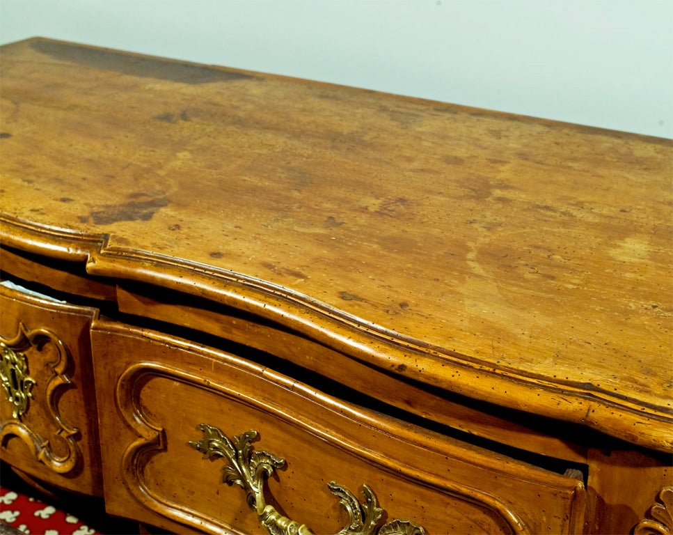 A French walnut commode with beautiful carved drawer fronts and legs.  This Very Handsome 
