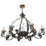 20th Century patinated iron eight light chandelier