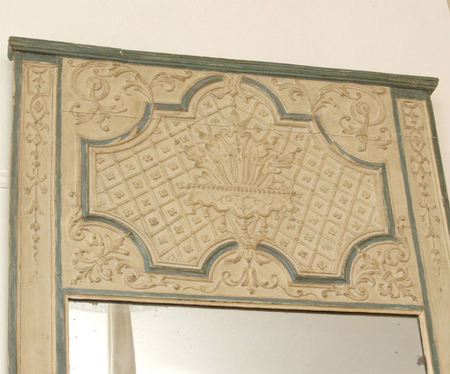 Painted in creme color with hints of French blue - low relief carving on the frame