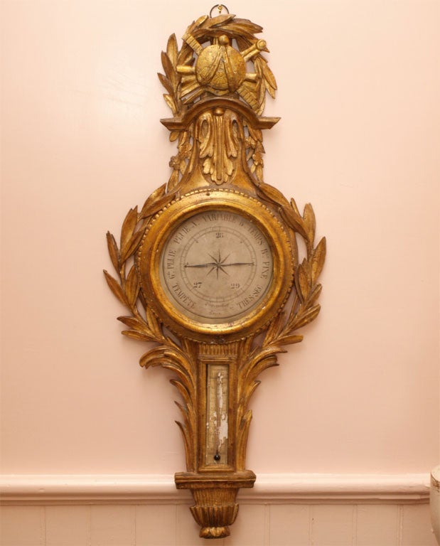 Louis XVI period giltwood barometer with armorial motifs at top and carved acanthus leaves.