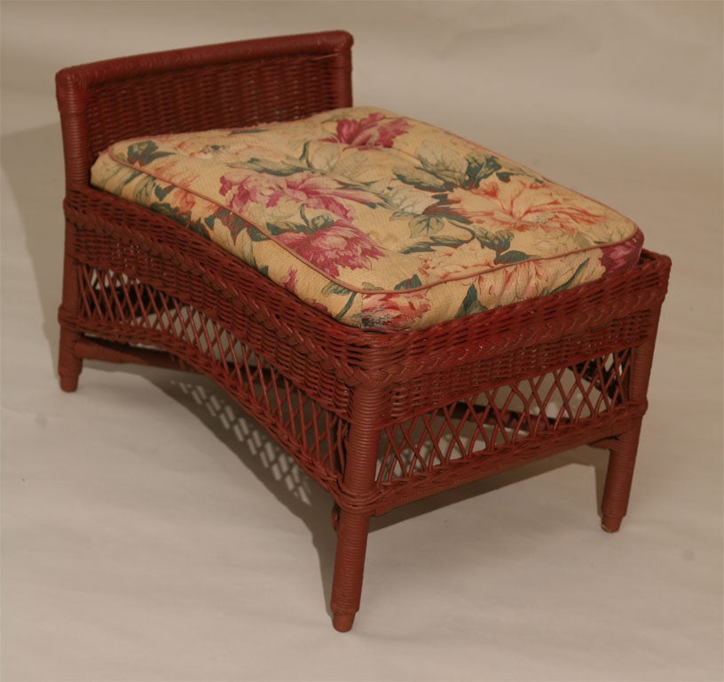 Bar Harbor style wicker ottoman in red painted finish. Can be re-painted any custom color on request.  Angled recline to wicker gallery designed to hold cushion in place.  Coiled spring platform.