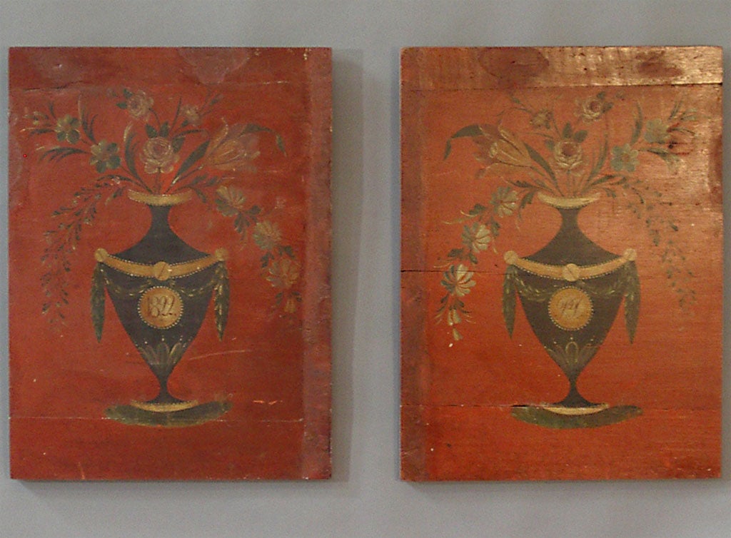 Pair of wooden panels with original painted flower and urn motifs. These were probably removed from a painted armoire. Sweden, dated 1822.