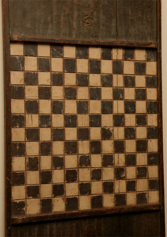 Lets play checkers or chess. We recently found this wonderful Canadian game board. It is incised on the squares of the playing surface and painted a wonderful olive green color with cream color squares. From the Quebec region. this would be a