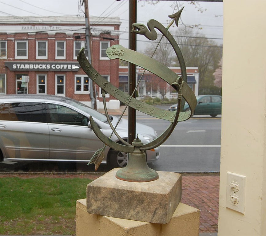 Bronze armillary sphere on marble base with exceptional weathered patina.