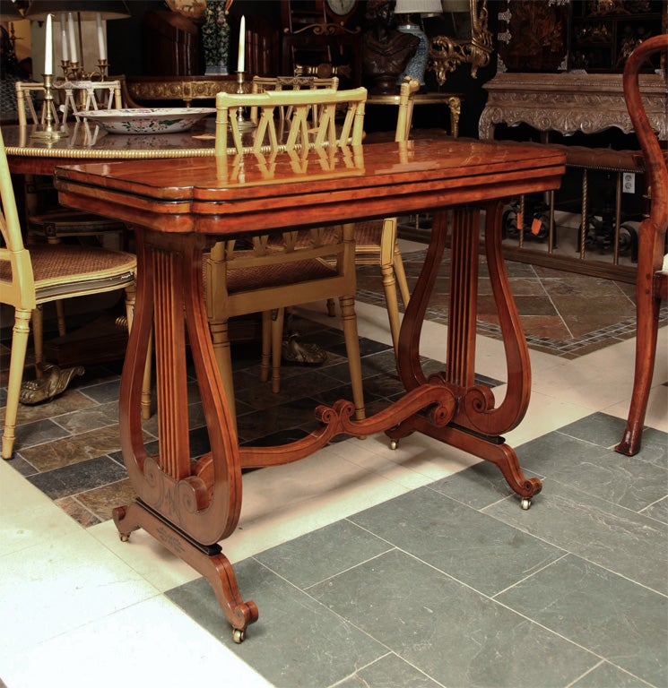 Fine Regency flip top card table with lyre end supports and stencil decoration.