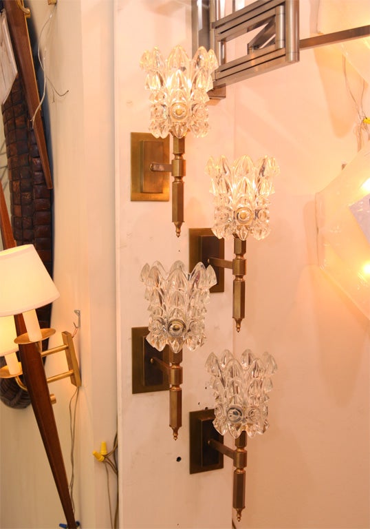 Pair of brass torch form sconces with clear glass shade
