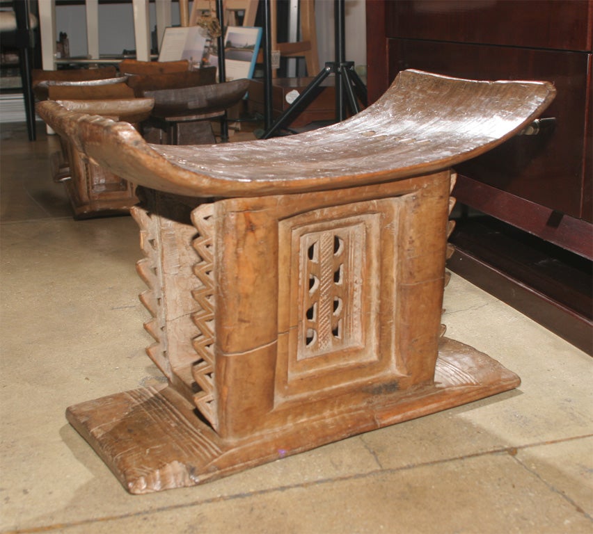 Asante Stools from Ghana. Hand carved.  All have a simple curved seat and a central base uniquely carved.  Highly useful as side oe end tables. Sizes vary in height, width and depth.  Above items are large.  Heights range 15 1/2