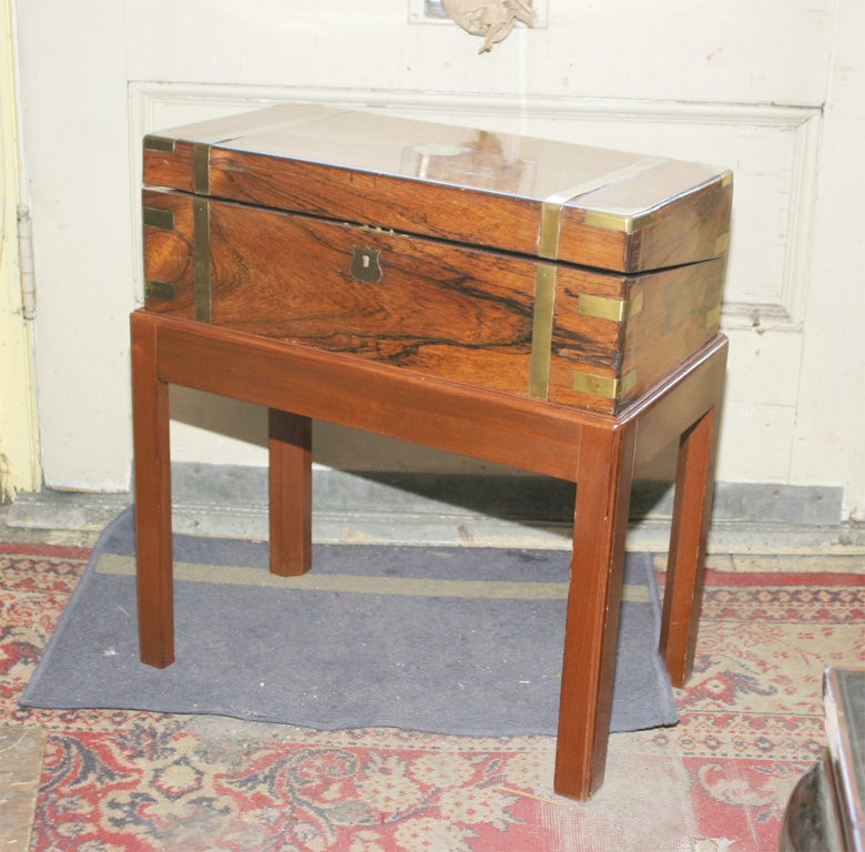 A fine antique English Regency rosewood and brass trimmed lap desk now mounted on a later mahogany stand.