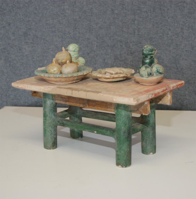 miniature earthenware table with offerings