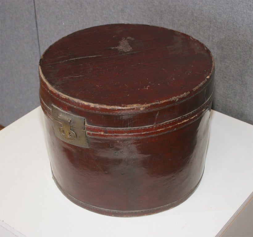 cylindrical leather and cotton lined hat box with bronze fittings