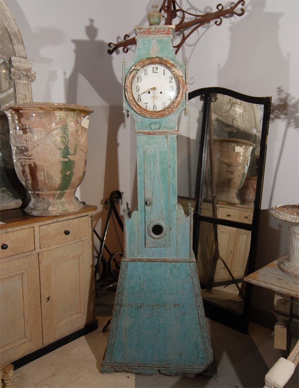Swedish mora clock in its original finish and retaining its original works and pendulum.  Beautiful color, shape, and details.