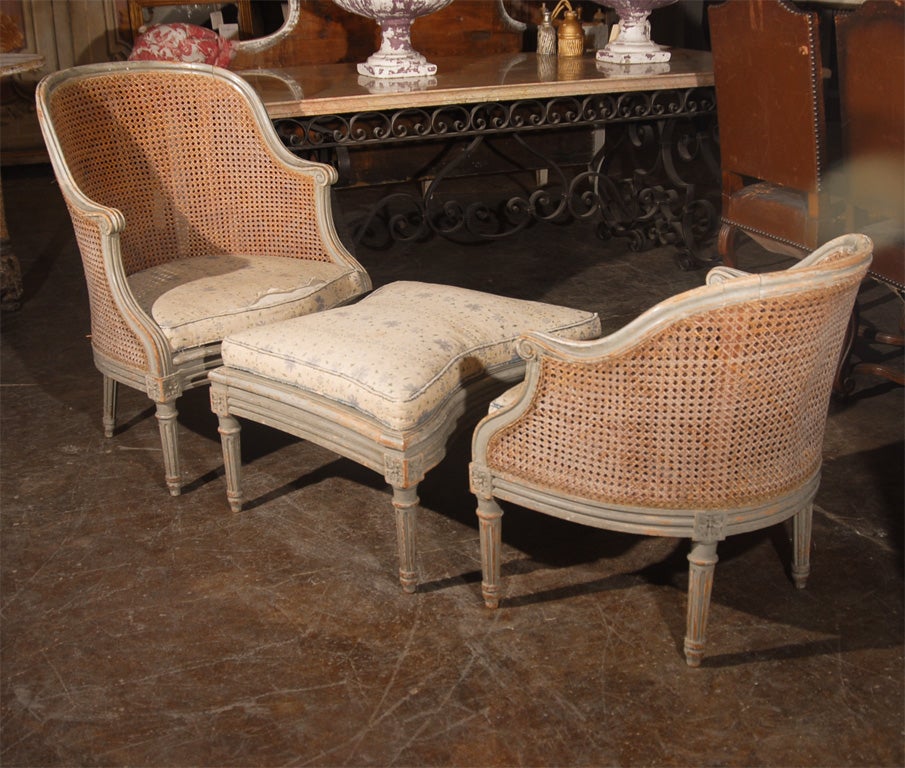 Caned and painted pale blue grey duchesse. Cushions covered in slubby linen.