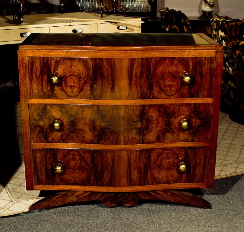 Vintage mahogany and burl wood dresser with eglomise glass top. Fleur de lir motif.