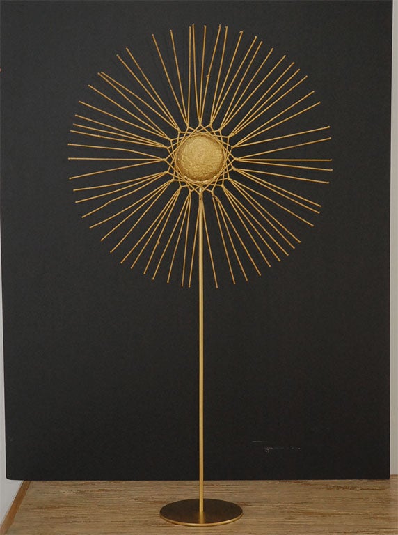 Iconic gold painted metal starburst sculpture on stand- with votive candle at back- from famed sculptor and designer Tony Duquette.<br />
<br />
We have full provenance on the piece, as well as illustrations of similar Duquette work.