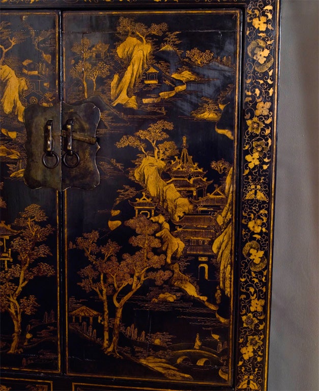20th Century Tall gilded black lacquer compound cabinet.