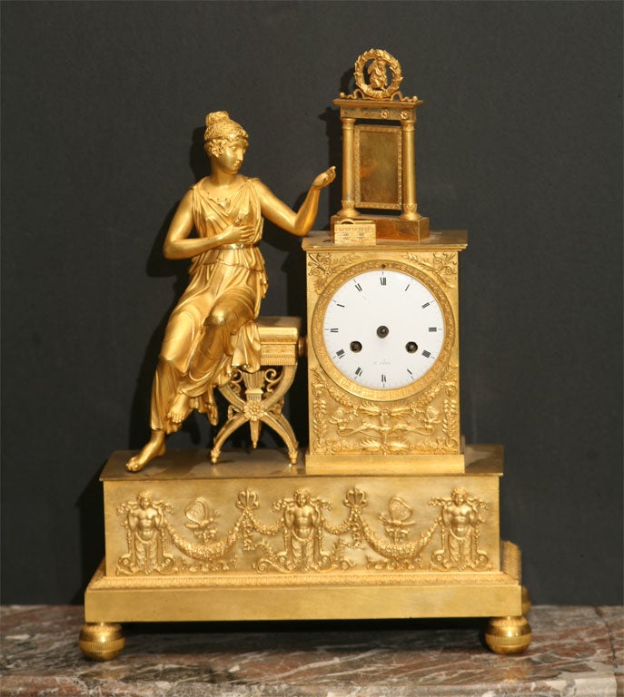 A very finely cast gilt bronze clock depicting Psyche at her toilet. The reflective mirror of polished bronze and that each element is cast separately then screwed on is an excellent example of the level of craftsmanship seen through out this clock.