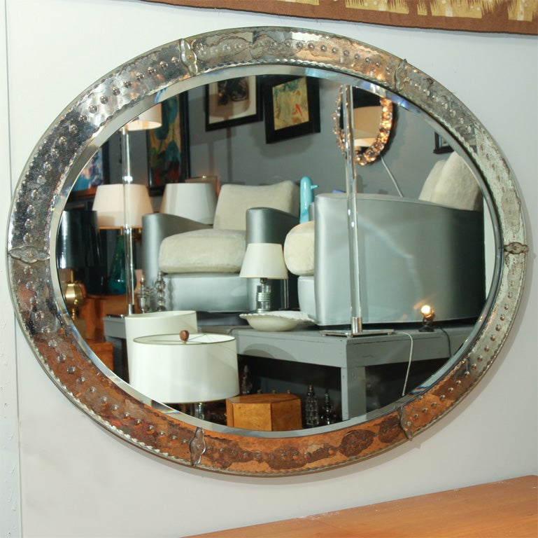 Oval mirror, the frame decorated with beveling and applied florets, French 1940s<br />
40