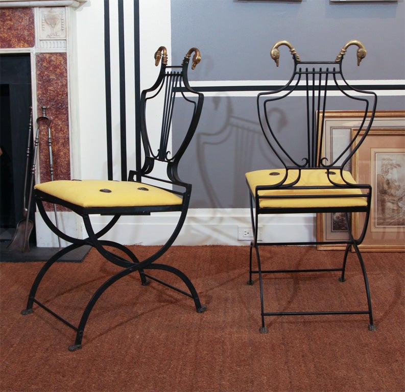 Pair of Neoclassical brass-mounted steel folding chairs.