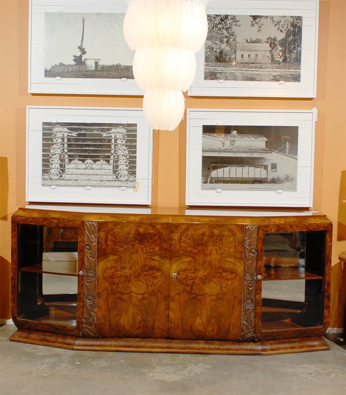 Circassian walnut art deco sideboard with carved pilasters and glass doors.  Mirrors in  back of each cupboard. Original Price $17,500