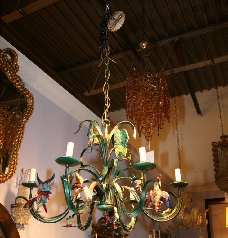 This wonderful chandelier is filled with life and personality. It has 6 lights and is fully rewired.   There are three big roosters, two baby chickens and seven birds.  It is screaming 