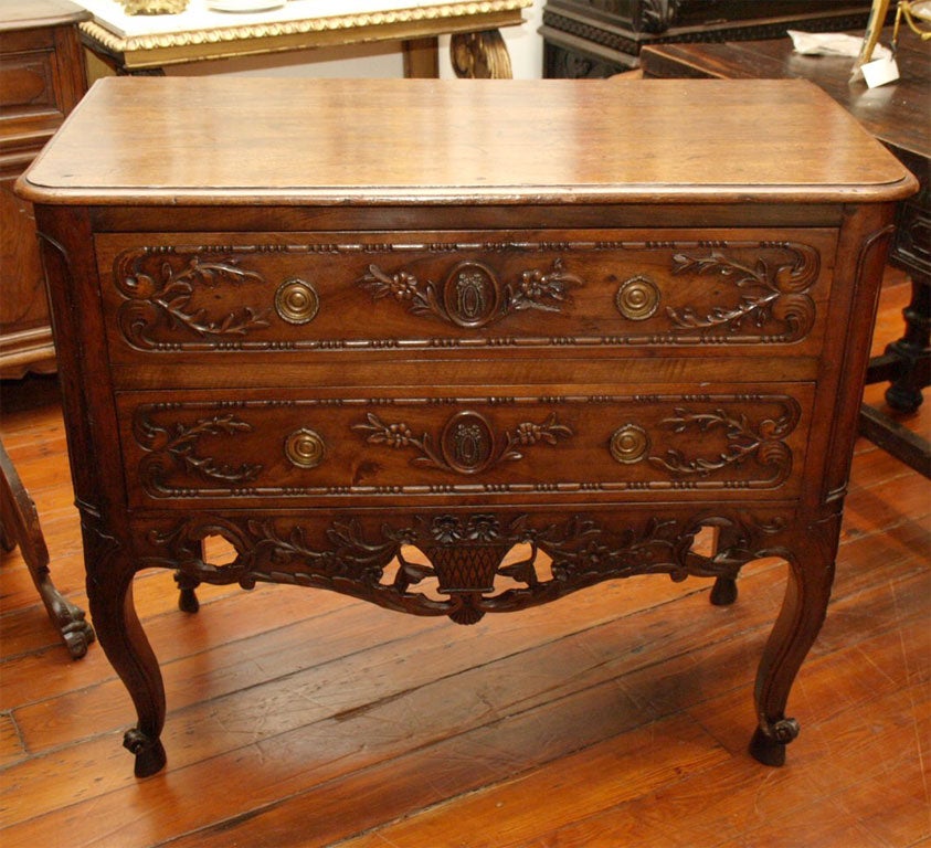 Period Louis XV Sauteuse (two drawer commode) from Arles France of Walnut with wonderful carving.