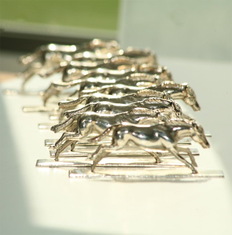 SET OF TEN SILVERED BRONZE KNIFE RESTS