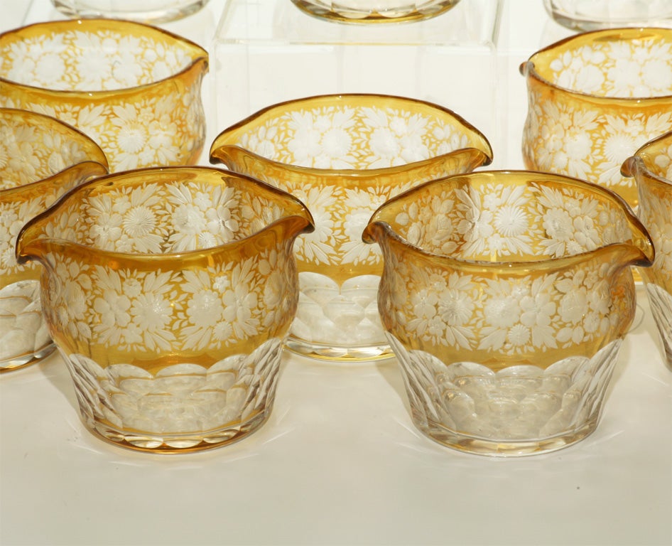 Set of ten Bohemian handblown crystal wine rinsers with amber overlay and cut to clear floral decoration. The clear bottom is cut in a honeycomb pattern and the base has a polished pontil. These also make wonderful individual vases or grouped down