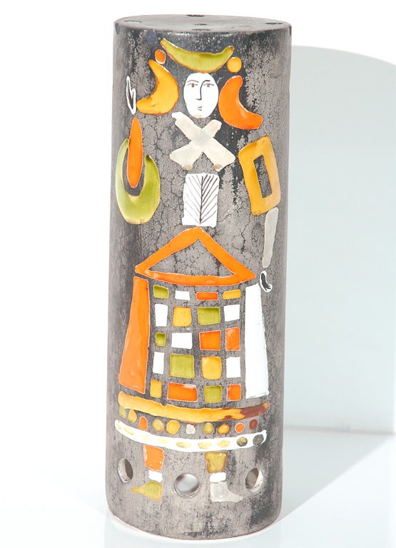 This charmingly hand-painted ceramic cylinder is a shade for a pendant lamp.