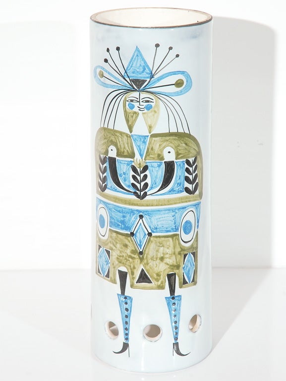 This charmingly hand-painted ceramic cylinder is a shade for a pendant lamp.