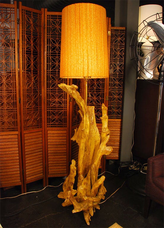 Crafted from a large piece of Pacific driftwood, this floor lamp stands over five feet tall. The knubby orange yarns of the original vintage shade (20 inches tall) highlight the warmth of the wood under a scrim of plaster.