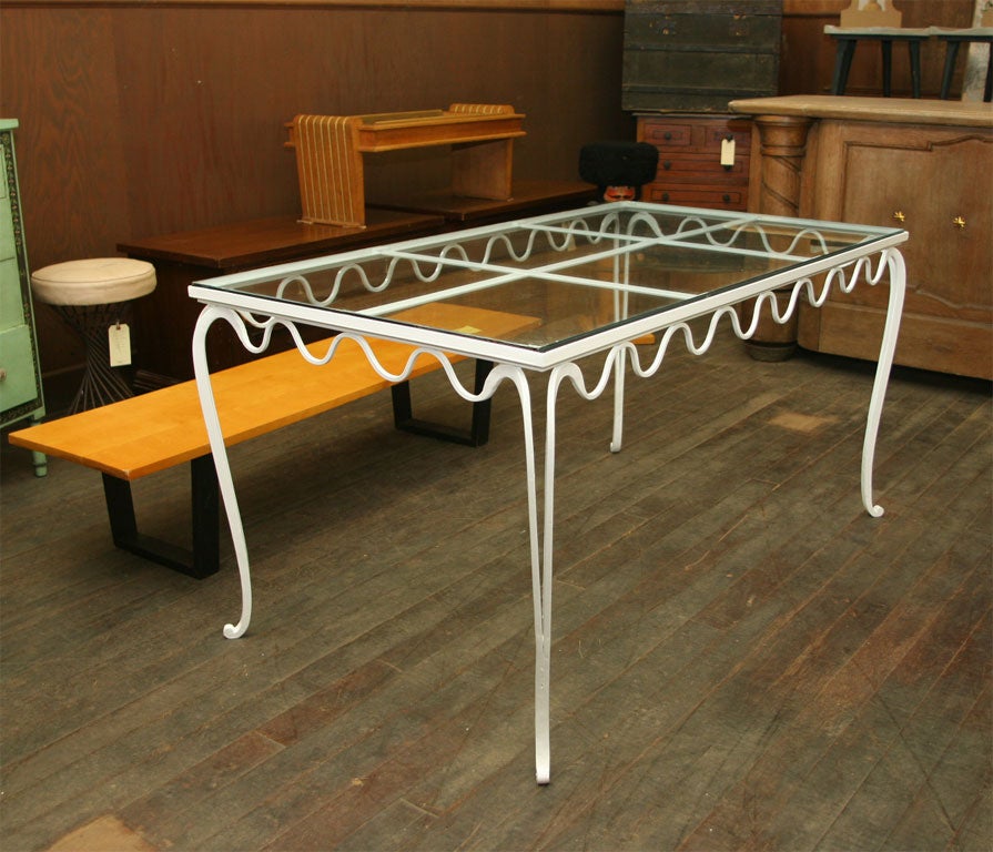 White painted, scalloped French wrought iron table with a glass top. Heavy, fine quality.