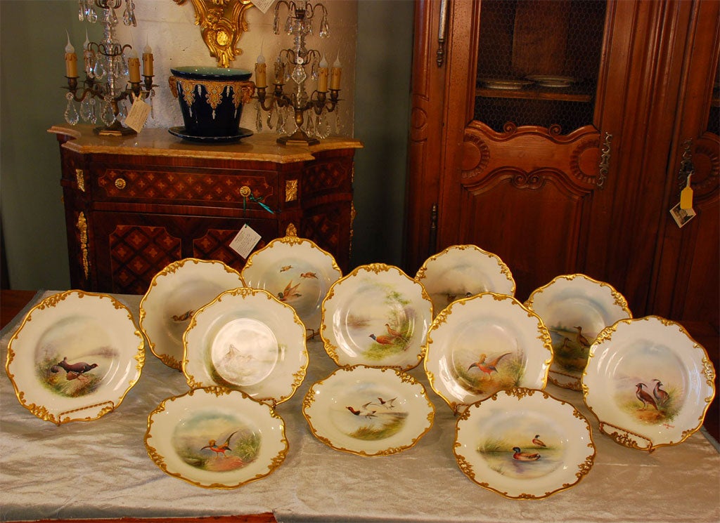 Set of 12 Doulton hand-painted bird plates, signed by the artist 