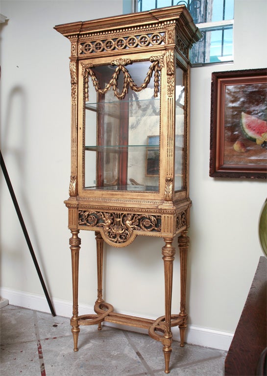 19th Century French Gilt Wood Curio Cabinet With Glass Shelves,<br />
Two parts.