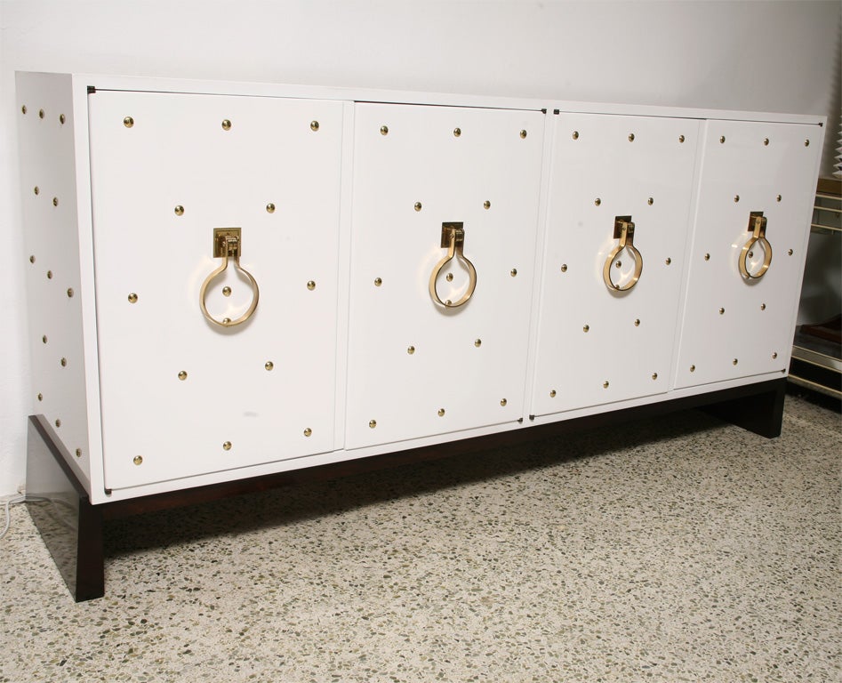 Tommi Parzinger 4 door Cabinet,<br />
Brass Hardware and studs to front and sides<br />
Marked Parzinger Originals