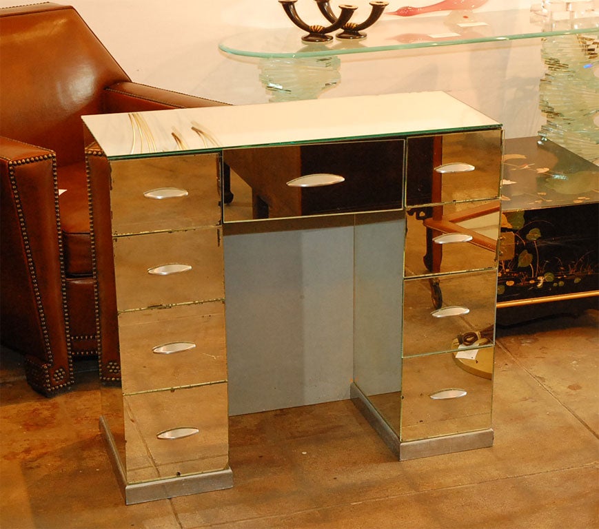 Mirrored vanity with silvered metal base and drawer pulls