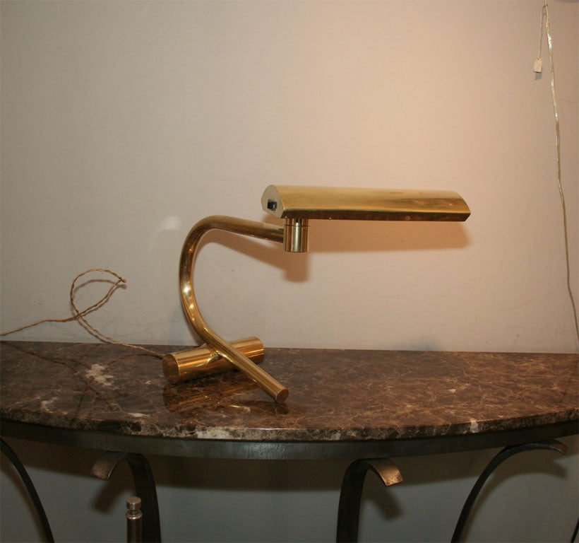 A pair of articulated modernist brass table lamps.