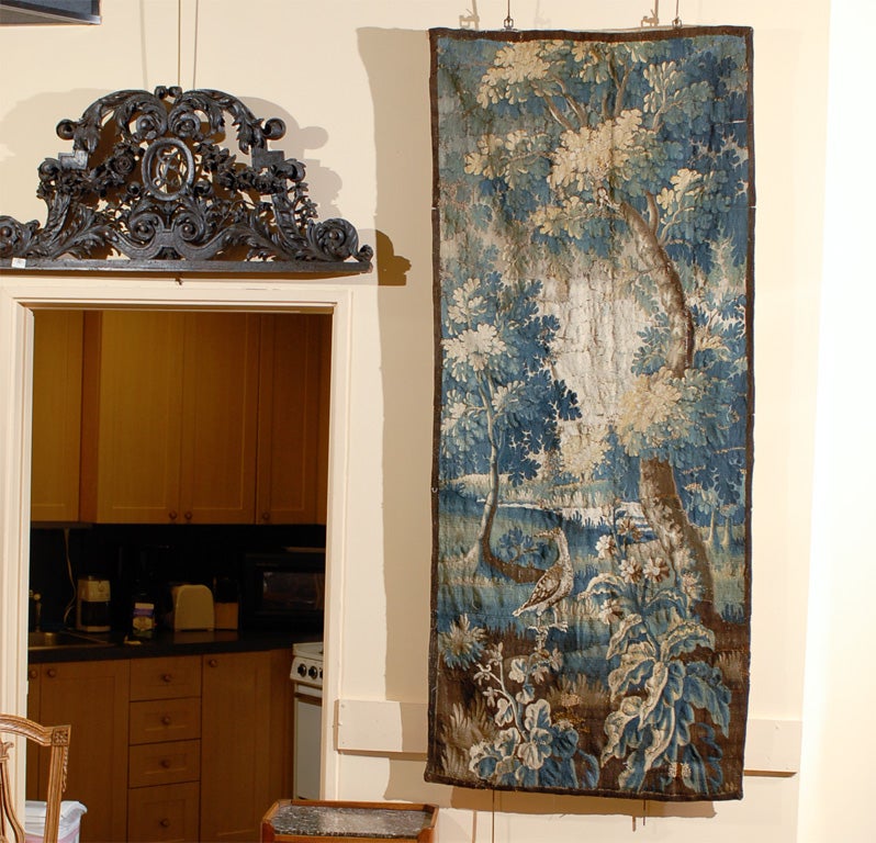 An aubusson tapestry fragment in blue and brown hues with foliage and birds scene. The aubusson dating from the 18th century and French in origin. <br />
<br />
For many more fine antiques, please visit our online galleries at: