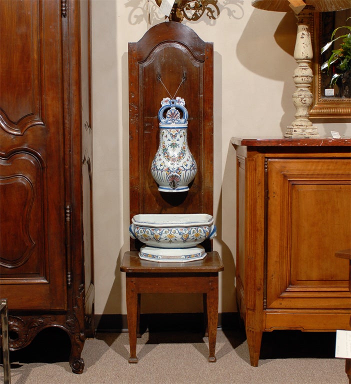 This beautiful faience wall fountain is from Rouen, a major pottery center in France since the 16th century.  Rouen faience has a thick and heavy composition made from local clays.  Their decoration is highly skilled and detailed as seen in this