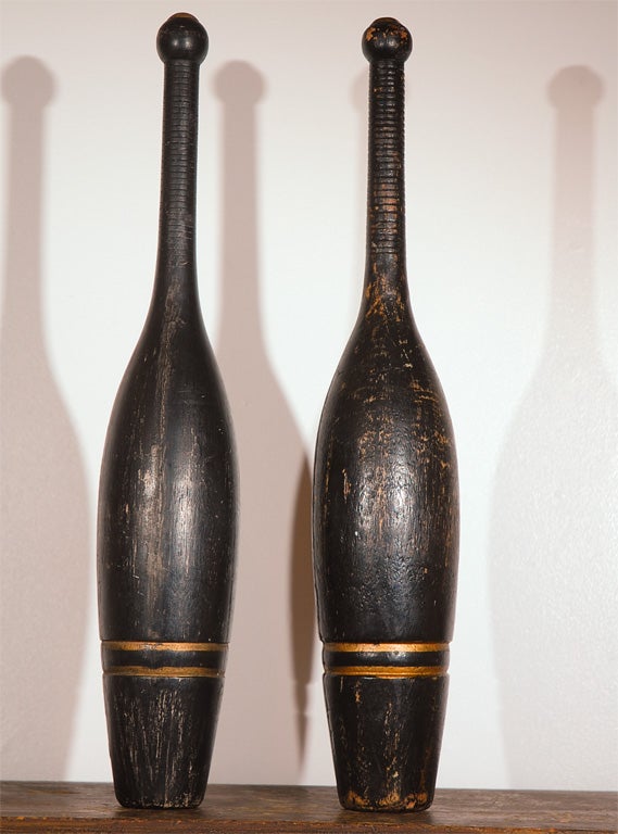 Great original black painted 19th century pins with outline in gilded paint trim. Tops of pins have an original brass cap. The simplicity of these pins and form are very folky. Great size. Sold as a pair.