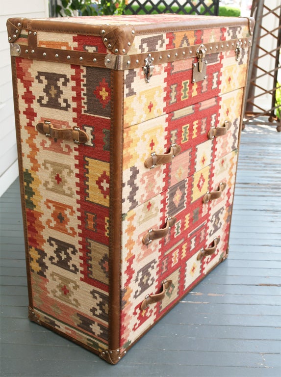 This very heavy and well made truck style chest of drawers is from the firm Andrew Martin.The chest is covered in a hand woven wool kilim, which is then finished off in nail heads with leather trimming,leather corner blocks, leather drawer pulls and