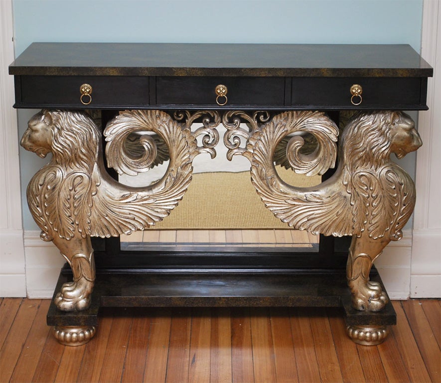 Three-drawer console by Maitland-Smith with hand-carved silver gilt front supports in the form of winged lions; the plateau and plinth in 