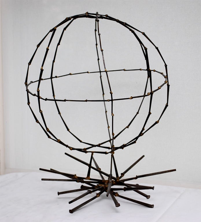 Globe sculpture in welded iron nails, clear lacquered