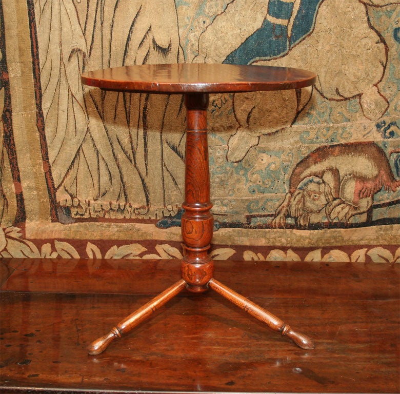 Rare and unusual 18th century English elm tripod table with balustrade turned shaft supported by turned legs ending in blunt arrow feet. This lovely example is in a perfect state of preservation, with no repairs and having excellent color. Often