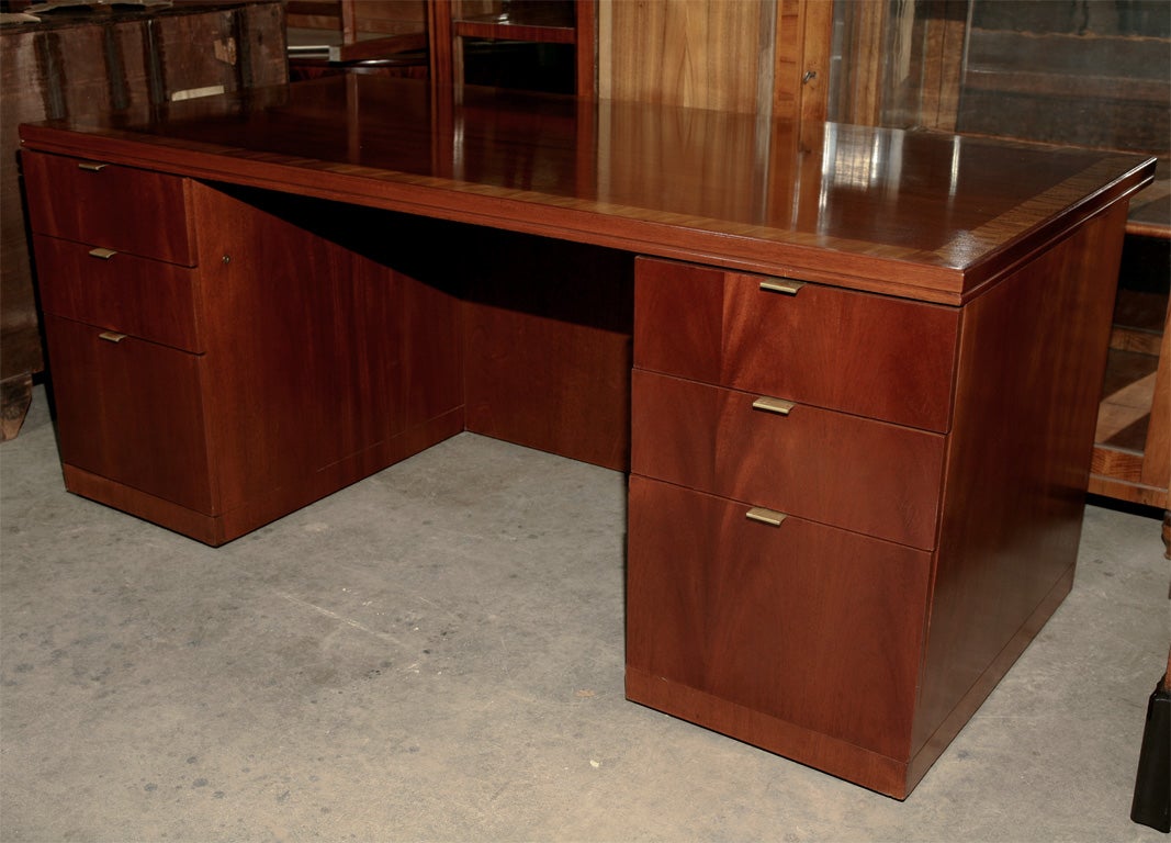 Large mohgany executive desk with brass plated handles.