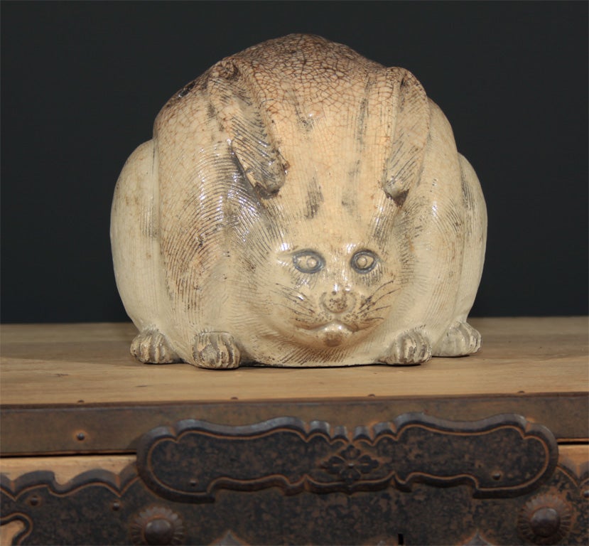 Japanese ceramic hand warmer (teburi) in the form of a crouching rabbit.  Hand warmers were traditionally placed out during the winter for a little additional warmth and to provide a place for a pipe to be lit.  The stoneware rabbit with slightly